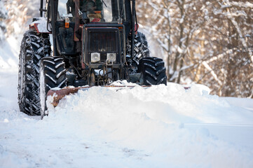 Tractor clearing snow from the road.