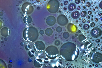Soap bubbles have created a unique texture pattern on a purple background.