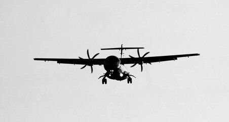 Airplane preparing the landing with a blue sky