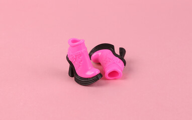 Trendy doll boots on pink background. Minimal fashion layout