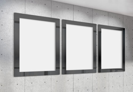 Three vertical frames Mockup hanging on wall. Mock up of billboards in modern concrete office interior 3D rendering