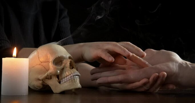 Predict future by hand. A fortune teller predicts fate in the palm of her hand.