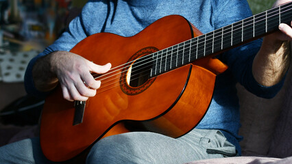 Obraz na płótnie Canvas a man plays guitar at home