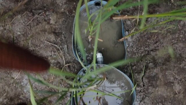 Overhead shot of a bio-filter installed on the edge of a forest to filter out impurities from nearby grey water tank.
