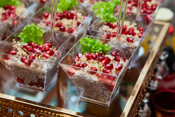 Snack at the buffet at the event. An assortment of snacks on a tray. Banquet service, restaurant on the road. Food, snacks with meat, ham, bread and tomatoes, seafood snacks, salmon, ham, caviar