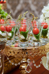 Snack at the buffet at the event. An assortment of snacks on a tray. Banquet service, restaurant on the road. Food, snacks with meat, ham, bread and tomatoes, seafood snacks, salmon, ham, caviar