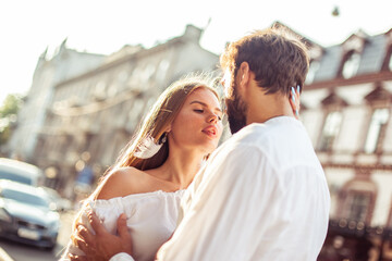 Romantic portrait of a couple in love in the city at bright day