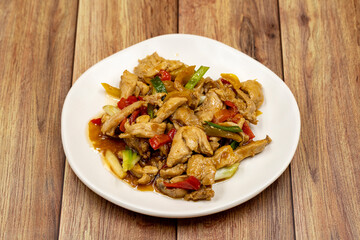 Chinese chicken dish. Chicken with olive oil and soy sauce. Traditional Chinese dish prepared with garlic, onion, capia pepper and green pepper