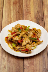 Chinese chicken dish. Chicken with olive oil and soy sauce. Traditional Chinese dish prepared with garlic, onion, capia pepper and green pepper