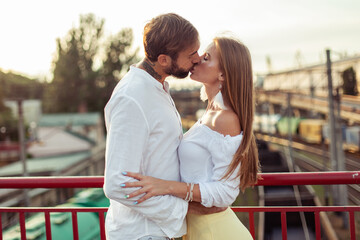 Young couple in love kissing in urban location. Romantic concept