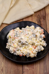 Potato salad with mayonnaise. Traditional salad with cooked vegetables with mayonnaise. Russian salad