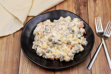 Potato salad with mayonnaise. Traditional salad with cooked vegetables with mayonnaise. Russian salad