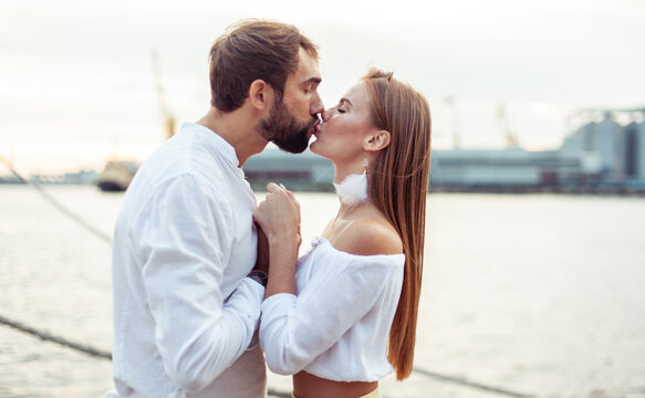Portrait of a couple in love at the sea. Kissing man and woman