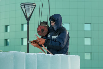 Worker in blue jacket unloading ice panels