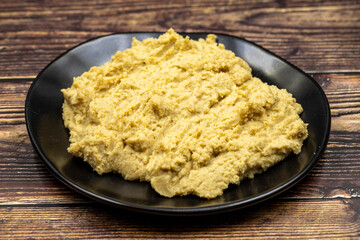 Hummus in a ceramic plate. Dishes of chickpeas, a vegetarian dish.