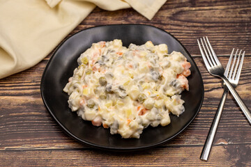 Potato salad with mayonnaise. Traditional salad with cooked vegetables with mayonnaise. Russian salad