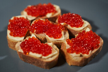 close-up red caviar sandwiches on white bread and butter