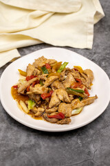 Chinese chicken dish. Chicken with olive oil and soy sauce. Traditional Chinese dish prepared with garlic, onion, capia pepper and green pepper