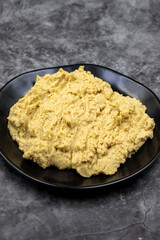 Hummus in a ceramic plate. Dishes of chickpeas, a vegetarian dish.