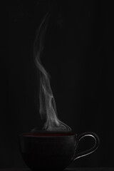 Cup of hot tea with black background