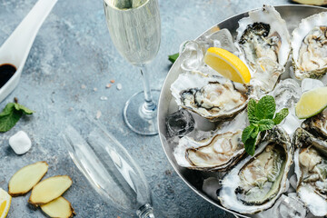 Oysters with wine, lemon, and ice. oysters dish. Oyster dinner with champagne in restaurant. banner, menu, recipe place for text, top view