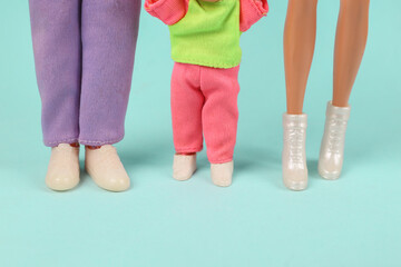 The concept of a complete loving family. Doll dad, mom and little daughter on a blue background