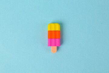 Plastic model of frozen juice ice cream on blue background