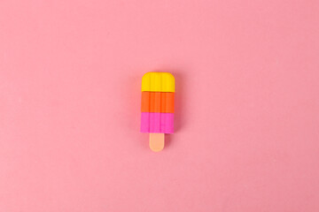 Plastic model of frozen juice ice cream on pink background