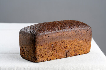 freshly baked bread on light kitchen table and gray background