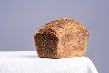 freshly baked bread on light kitchen table and gray background