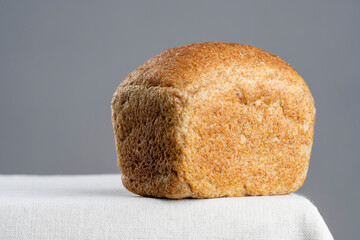 freshly baked bread on light kitchen table and gray background