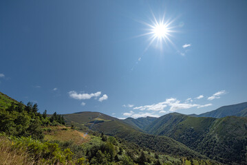 Landscape with mountains and sunbeams at dawn.