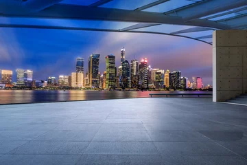Fototapeten Panoramic skyline and modern commercial office buildings with empty square floor in Shanghai at night, China. empty road and cityscape. © ABCDstock