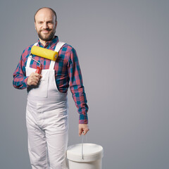 Professional painter posing with paint roller © StockPhotoPro