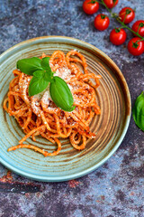 Spaghetti  bolognese .Italian home made meal Fresh  bucatini pasta with tomato sauce, basil, herbs ,parmesan cheese ,fresh cherry tomatoes and parsley on wooden background. Kitchen Poster 