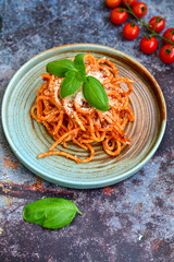 Spaghetti  bolognese .Italian home made meal Fresh  bucatini pasta with tomato sauce, basil, herbs ,parmesan cheese ,fresh cherry tomatoes and parsley on wooden background. Kitchen Poster 