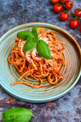Spaghetti  bolognese .Italian home made meal Fresh  bucatini pasta with tomato sauce, basil, herbs ,parmesan cheese ,fresh cherry tomatoes and parsley on wooden background. Kitchen Poster 