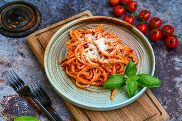 Spaghetti  bolognese .Italian home made meal Fresh  bucatini pasta with tomato sauce, basil, herbs ,parmesan cheese ,fresh cherry tomatoes and parsley on wooden background. Kitchen Poster 
