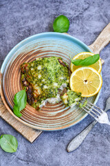 Fish bake refined with  spinach and gorgonzola cheese crust.White Code fish fillet stuffed  with broccoli  and  creamy Alfredo  sauce . Healthy food, delicious homemade italian  lunch .