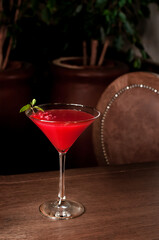 raspberry cocktail on bar interior background