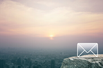 Mail flat icon on rock mountain over aerial view of cityscape at sunset, vintage style, Business customer service and support online concept