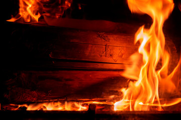 Burning wood in a fireplace. The beginnings of a fire. . Copy space.