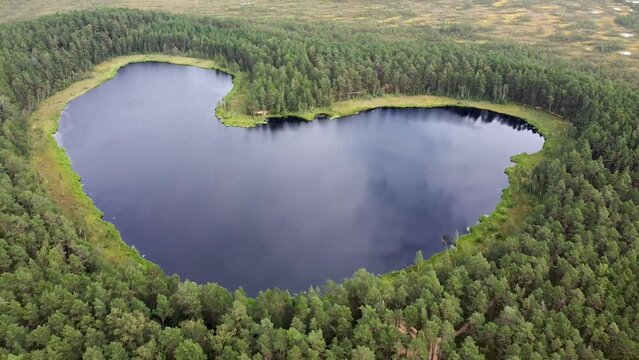 Aerial drone clip of a heart-shaped Parika bog lake in Estonia