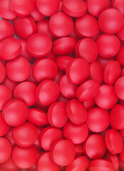 Red tablets as background.	