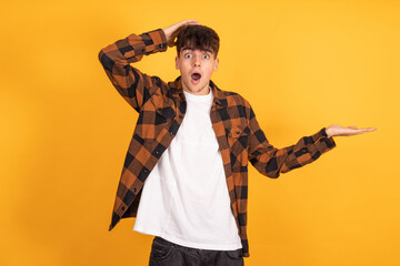 isolated teenager pointing with astonished expression