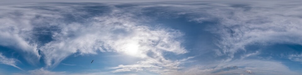Obraz premium Blue sky panorama with Cirrus clouds in Seamless spherical equirectangular format. Full zenith for use in 3D graphics, game and editing aerial drone 360 degree panoramas for sky replacement.