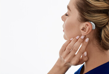 Hearing aids, hearing solutions. Woman enjoys a full life and can hear surrounding sounds thanks to a hearing aid behind her ear