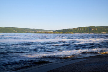 Obraz premium Nature landscape with beautiful water. Sea, river, lake, reservoir with blue waves. White foam on the wave