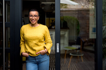 Fototapeta premium Cheerful happy satisfied smiling businesswoman or businessperson after a successful meeting. Adult person at the door of it's house looking at camera overwhelmed with success.