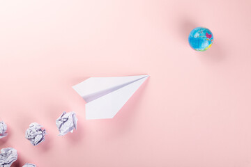 Paper plane tourism. Top view mock up design of airplane travel and globe, education or innovation...